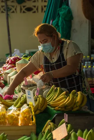 A vendor arranging fruit at the market