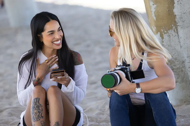 Liz and Shawni reviewing a shot on the sand