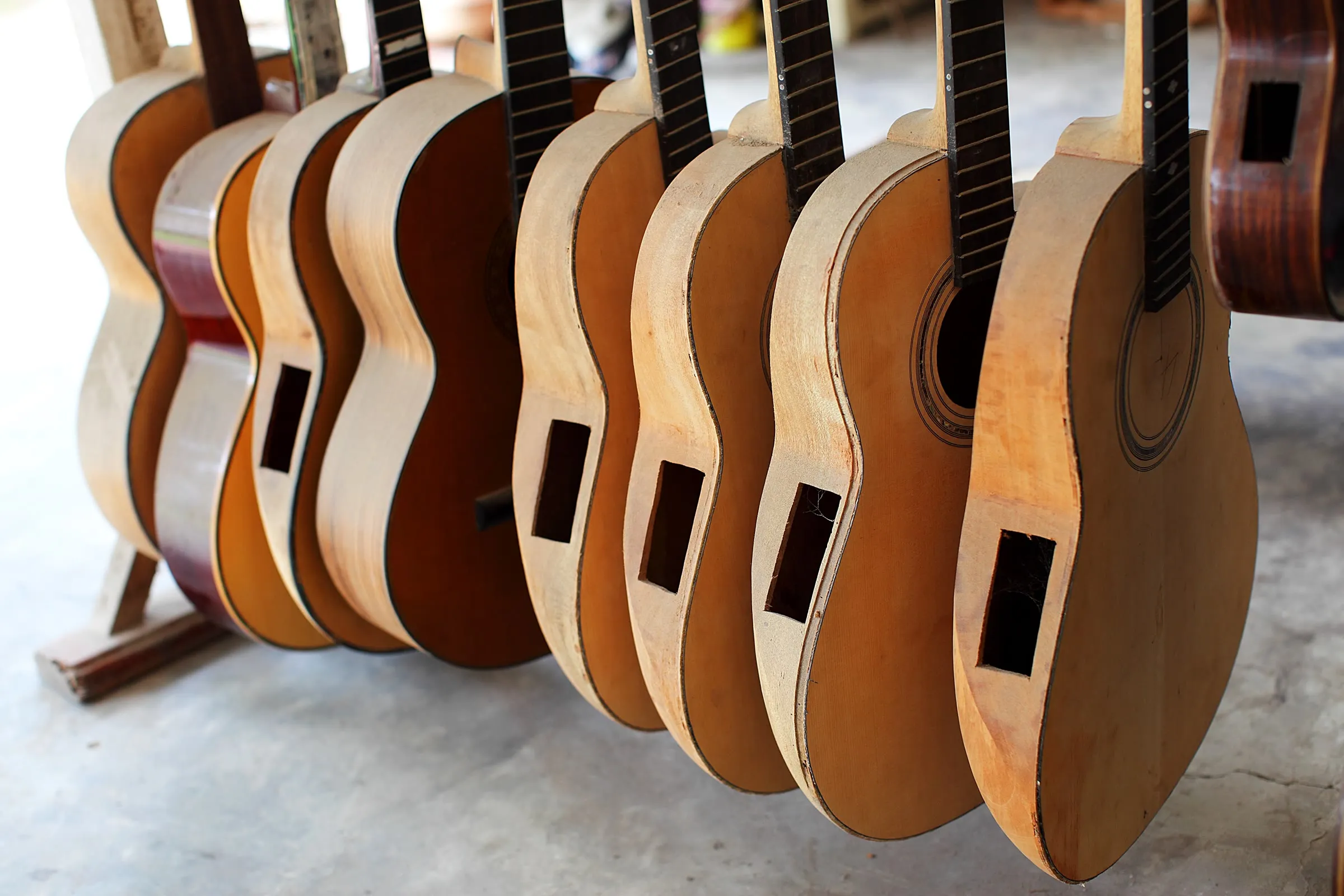 A row of handmade guitar bodies waiting to be finished