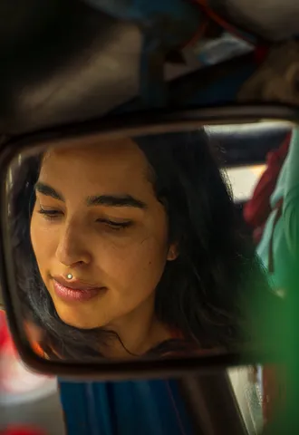 A portrait caught in a car mirror