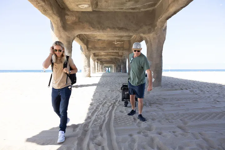 Two figures walking the length of the pier
