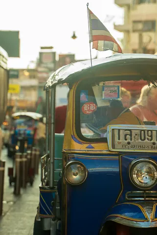 A tuk-tuk waiting in traffic